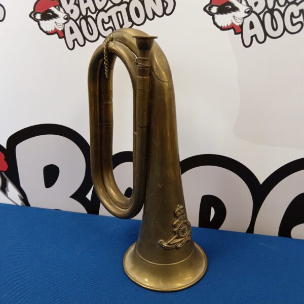 Antique brass Royal Artillery bugle horn, detailed view.