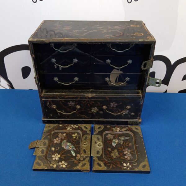 Antique Japanese lacquered cabinet with floral details.