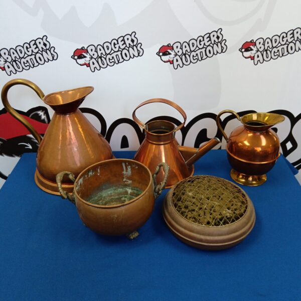 Vintage copper jugs and rose bowls on display, antique kitchenalia.