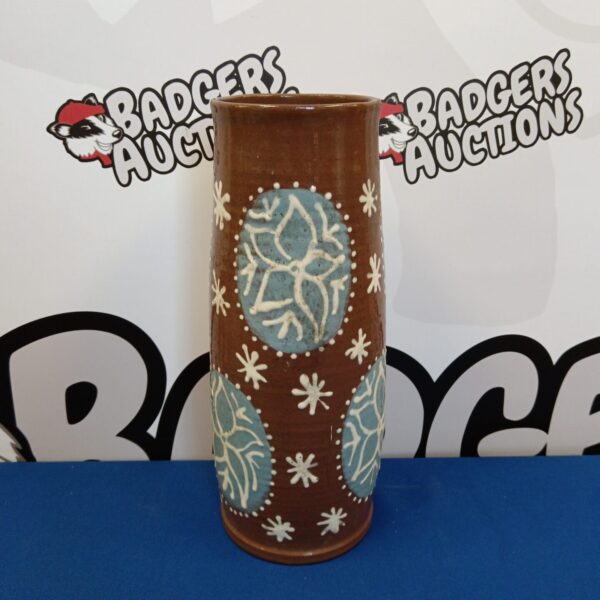 Close-up of a Tollow pottery vase with blue floral design.