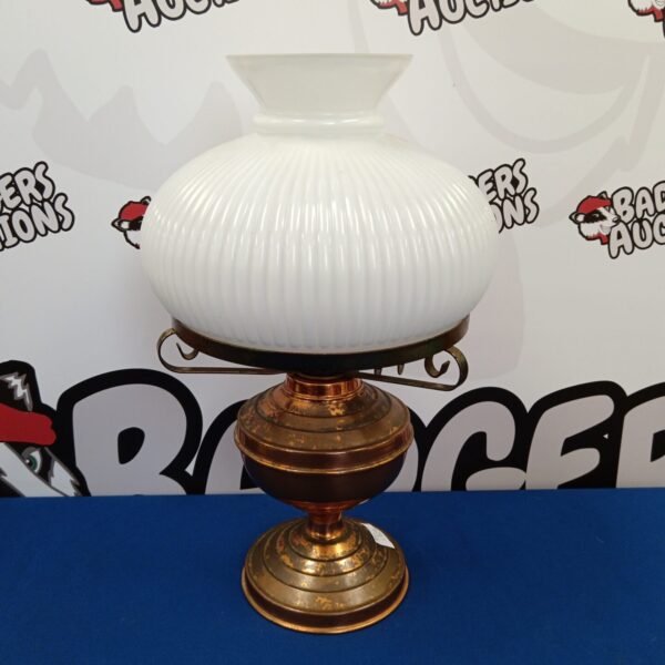 Vintage duplex oil lamp with brass base and frosted glass shade.