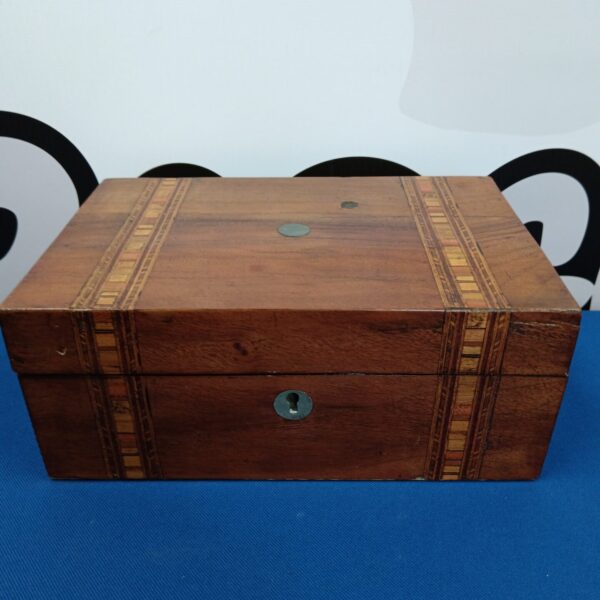 Vintage inlaid wooden jewellery box with detailed patterns.