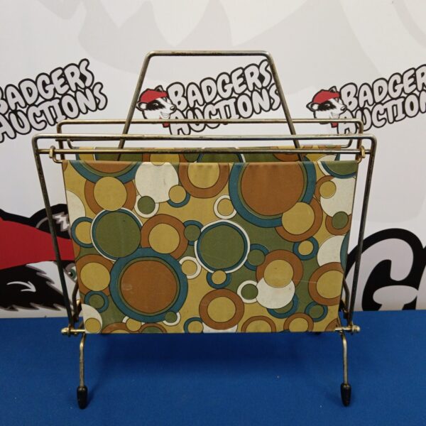 Vintage 1970s metal magazine rack with geometric pattern.