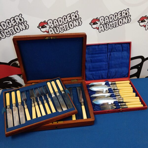 Vintage cased cutlery sets with bone handles and silver plated blades.
