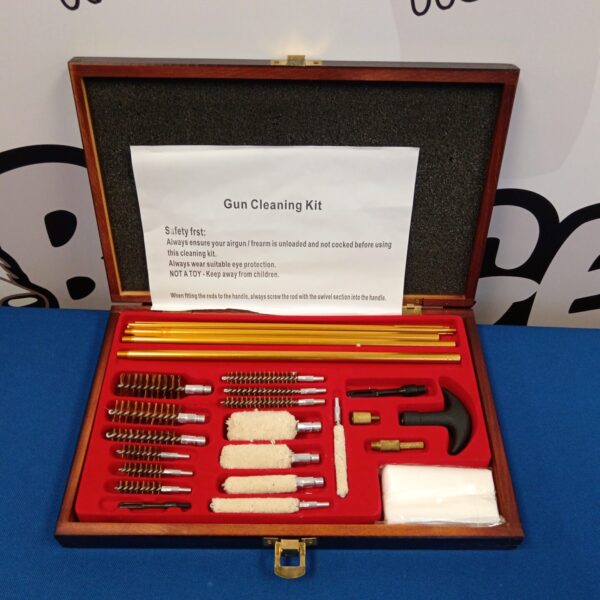 Vintage gun cleaning kit in wooden case with tools.