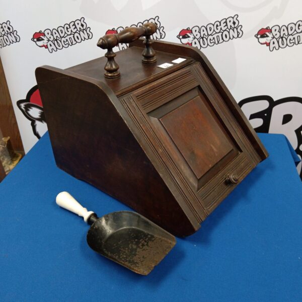 Vintage oak coal box with metal shovel for fireplace use.