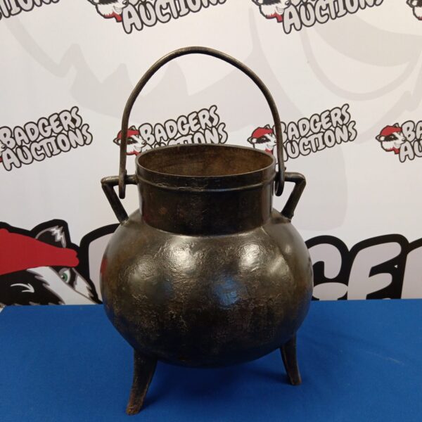 Vintage cast iron cauldron with legs and handle.