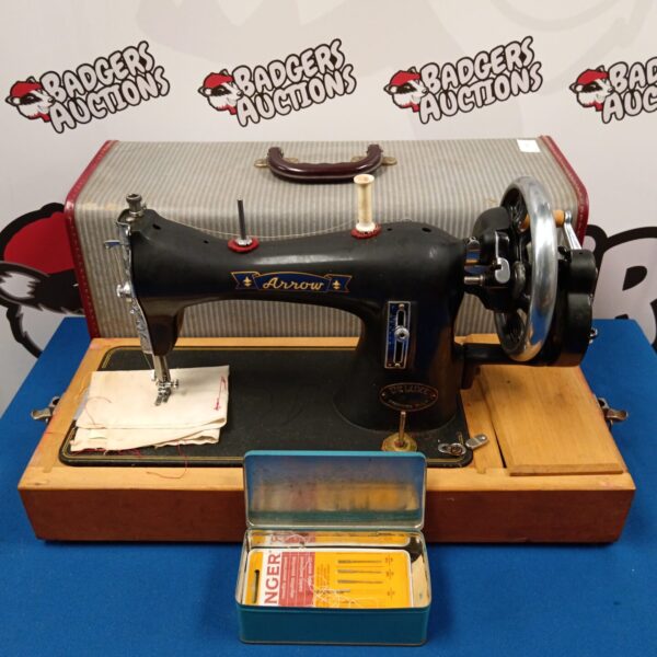 Vintage Arrow Deluxe sewing machine in original case.