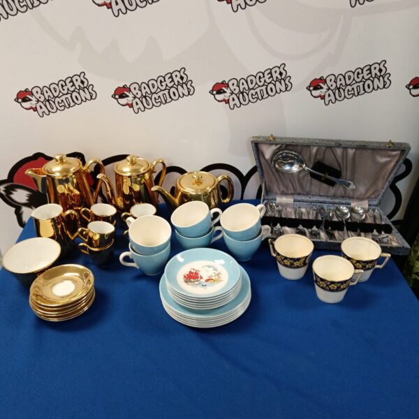 Vintage Royal Worcester gold lustreware tea and coffee set on display.