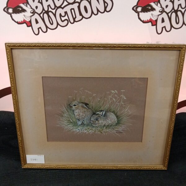 Signed R Timney pencil drawing of two rabbits in a field.