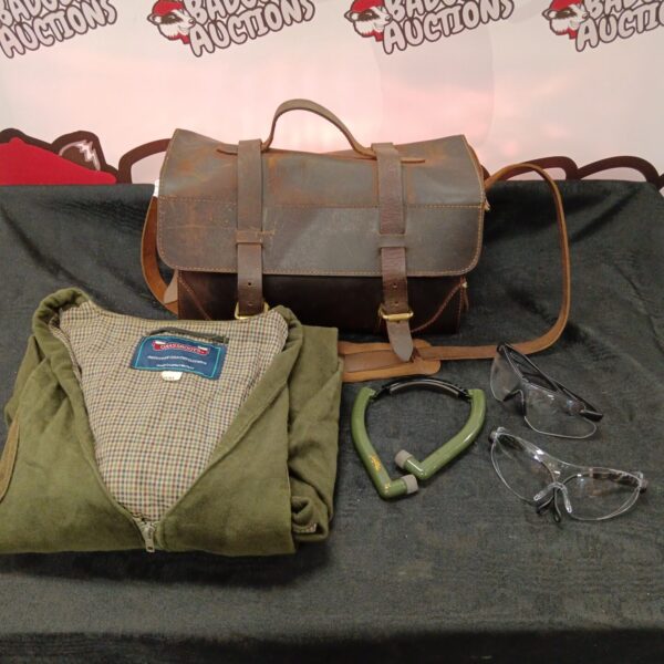 Vintage leather cartridge bag and green gillet for shooting.