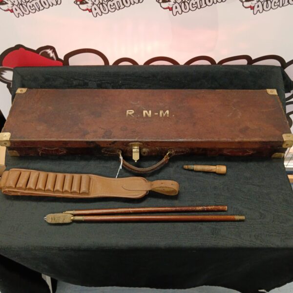 Full view of a vintage leather gun case with accessories.