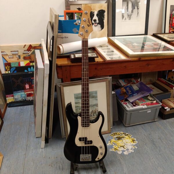 Black Rockburn bass guitar displayed against a bookshelf.