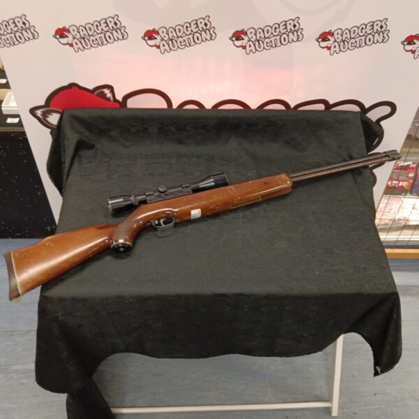 Vintage Weihrauch HE77 .22 air rifle with scope for target practice.