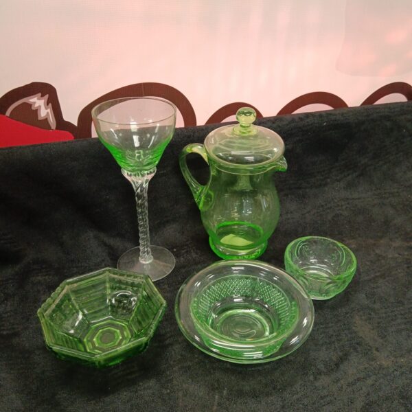 Vintage uranium glass lidded jug and green glass collection.