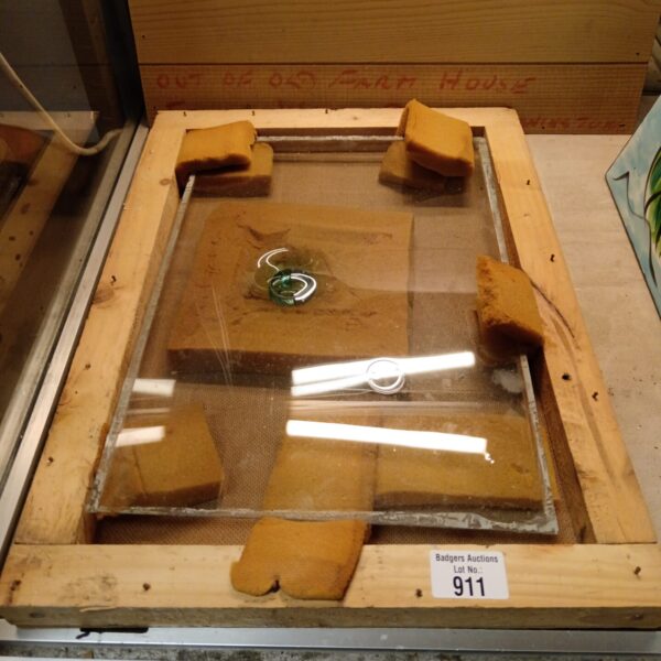 Antique bullseye glass panel with circular pattern.
