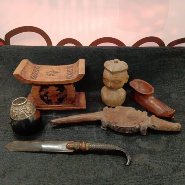 Vintage African carved wood figures and stool on display.