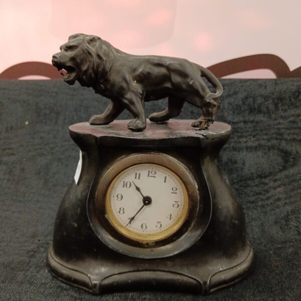 Antique Art Nouveau mantle clock with bronze lion sculpture.