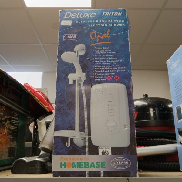 Triton Deluxe slimline electric shower in original packaging.