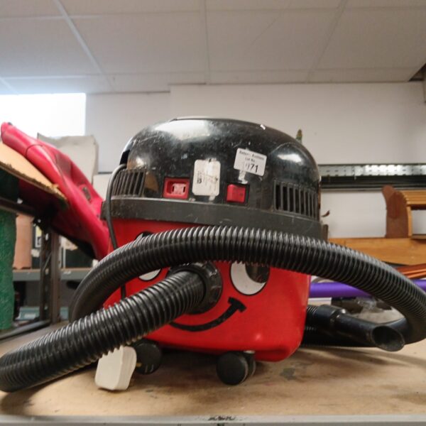 Red Numatic Henry vacuum cleaner with flexible hose.