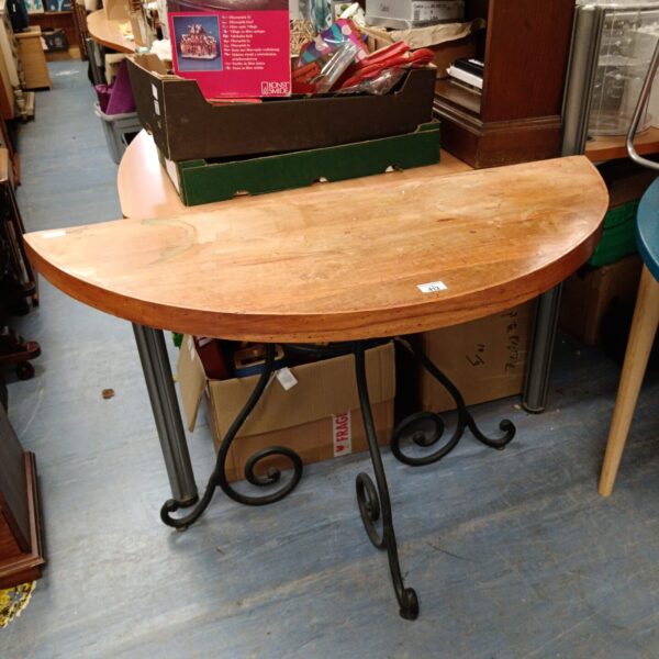 Vintage oak demi lune table with decorative cast iron legs.