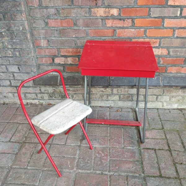Red vintage school desk and chair set, retro classroom furniture.