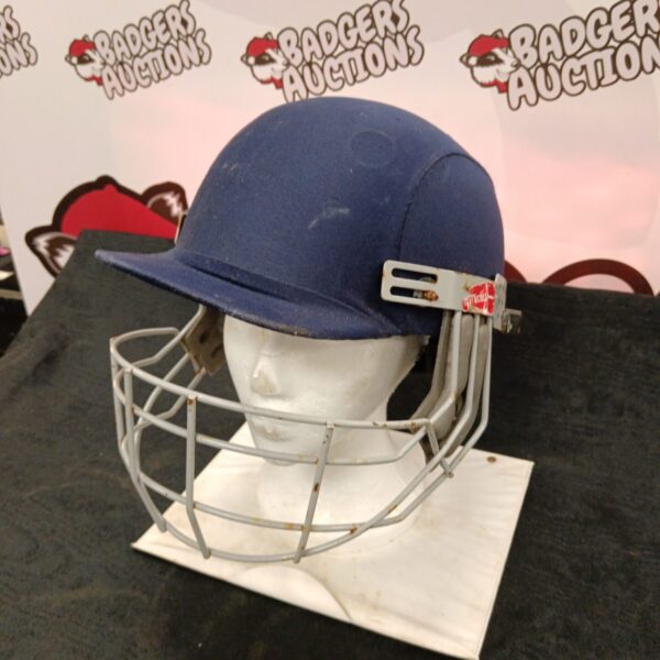 Front view of a vintage Gray Nicolls cricket helmet.