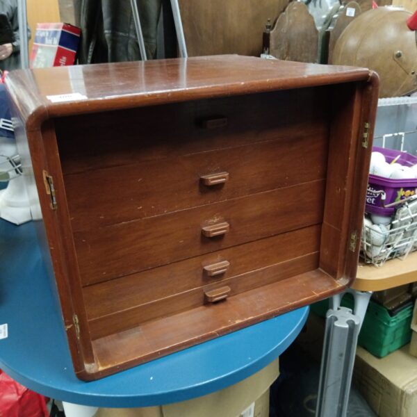 Vintage wooden engineers drawers on a blue table.