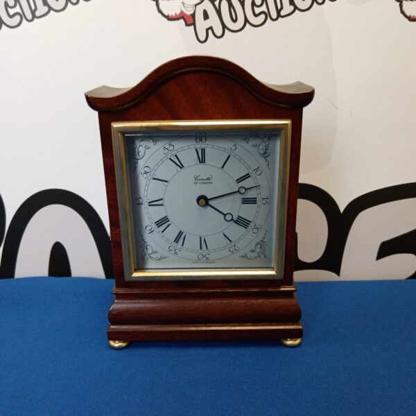 Antique Comitti mantle clock with white dial and mahogany case.