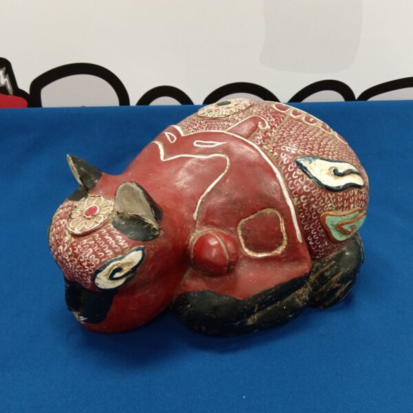 Vibrant hand-carved wooden cat sculpture with detailed painting.