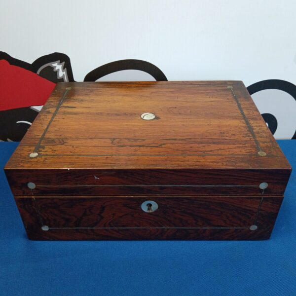 Vintage wooden box with mother of pearl inlay detail.