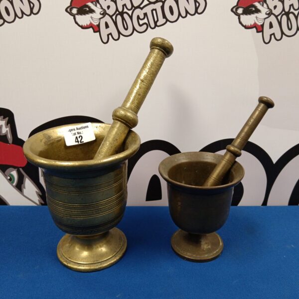 Antique brass pestle and mortars, vintage kitchen grinding tools.