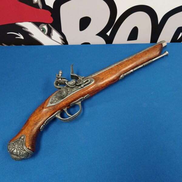 Antique flintlock pistol for display, detailed metalwork and wooden stock.