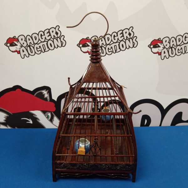 Detailed view of a vintage Chinese bird cage.