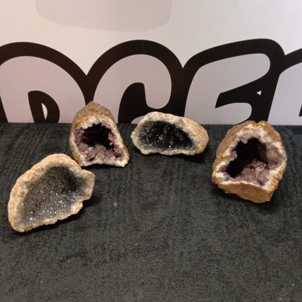 Four amethyst crystal geode rocks displayed for collection.