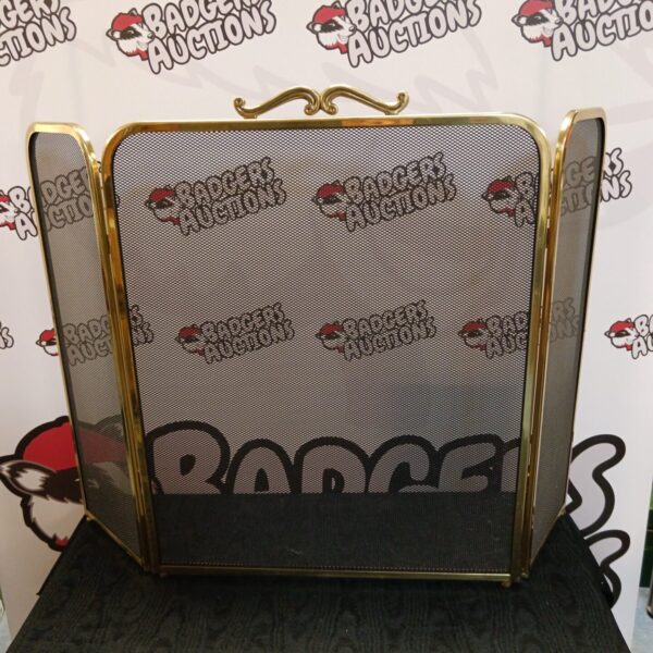 Vintage brass trifold firescreen for fireplace protection and decor.