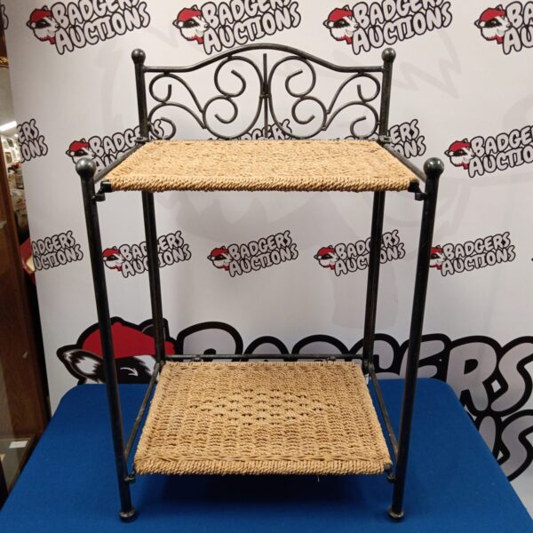 Vintage folding bedside table with wicker top and metal frame.