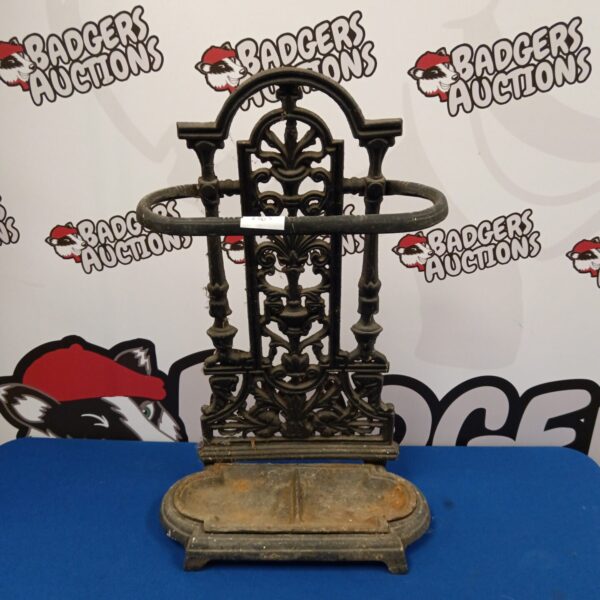 Ornate Victorian cast iron stick and umbrella stand for hallway decor.