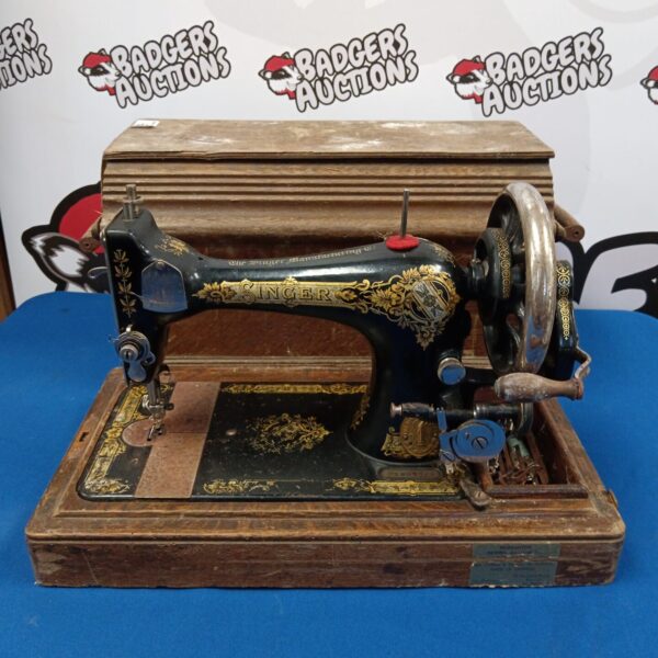 Antique Singer sewing machine model F1907749 on wooden base.