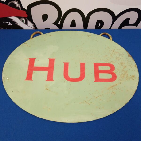 Vintage metal hub sign for industrial or retro decor.