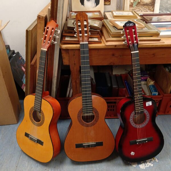 Natural finish acoustic guitar in a lot of three.