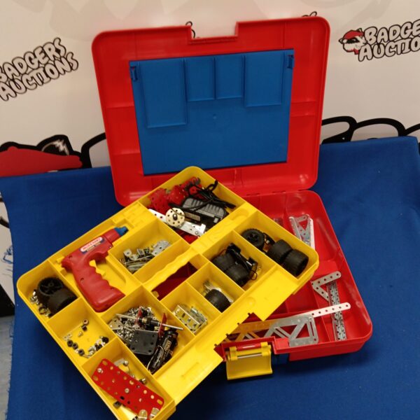 Vintage Meccano set in a red case with metal construction parts.