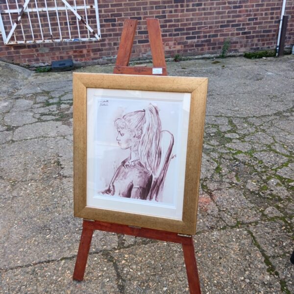 Sylrett David signed print displayed on a vintage artist's easel.