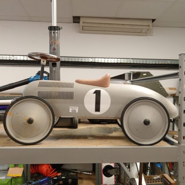Vintage metal ride on car with number one decal.