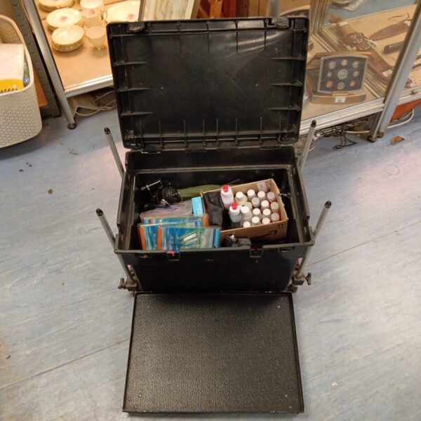 Open fishing seat box with tackle inside, angling equipment.