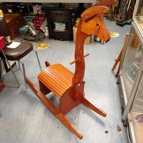 Vintage wooden rocking llama, a charming nursery toy.