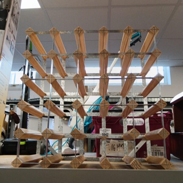 Wooden 25 bottle wine rack for home storage.