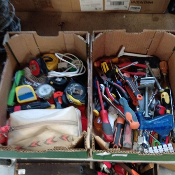 Tray of assorted hand tools and tape measures for DIY projects.