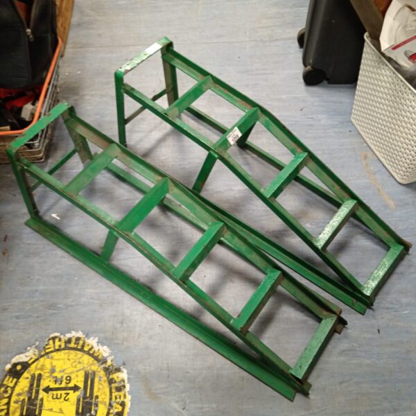 Pair of metal car ramps for vehicle maintenance and repair.