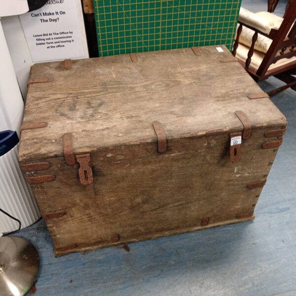 Large antique wooden campaign trunk with handles.